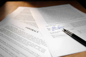 fountain pen lying on signed legal contract documents shot with shallow depth of field - signature is fake