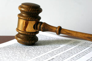 "Gavel on copy of escrow agreement, soft shadow.  White background, soft shadow. Gavel has seen much use.    Please see more gavel photos:"